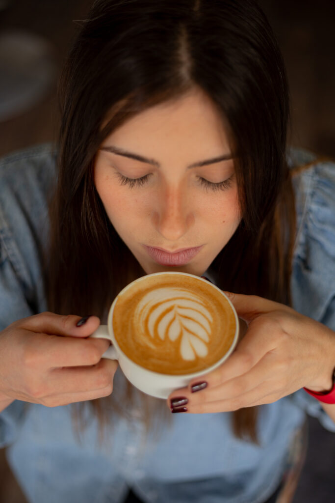 a woman holding a cup of coffee